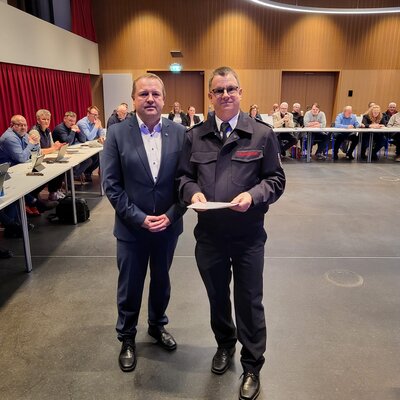 111Bürgermeister Mario Hecker [links] überreicht Gemeindebrandinspektor Arnd Plettemeier die Urkunde